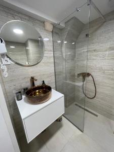 a bathroom with a sink and a glass shower at StonSoldo Rooms in Ston