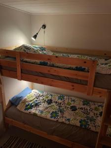 two bunk beds in a room with a lamp at Rosebo in Tranås
