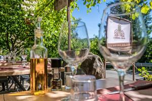 a bottle of wine sitting on a table with glasses at Hôtel Restaurant L'Arbre à Pain in Altier +17 photos