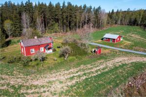 an aerial view of two red houses in a field at Rosebo in Tranås
