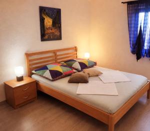 a bed with two pillows on it in a bedroom at Apartments Ivka & Garden in Senj
