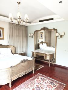 a bedroom with two beds and a large mirror at Heaven new Cairo Villa with Private pool and jacuzzi in Cairo +88 photos