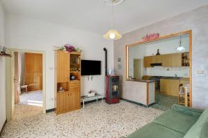 a living room with a couch and a large mirror at Bella veduta Sun in Agerola