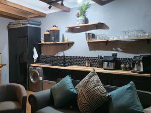 a kitchen with a stove and a couch in a room at Renosterveld Eco Pods in Swellendam +34 photos