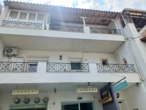 a white building with balconies on the side of it at Apartment Kasperakos in Skiathos +3 photos