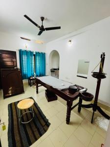 a living room with a ping pong table in it at iha ayurveda resort in Varkala +29 photos