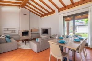 a living room with a table and a couch at Villa Selva in Manerba del Garda