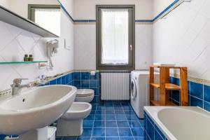 a bathroom with a sink and a toilet and a tub at Villa Selva in Manerba del Garda +30 photos