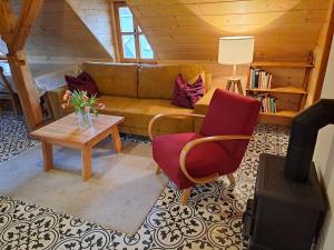 a living room with a couch and two chairs and a table at Sudetský grunt Autentická jesenická chalupa in Loučná nad Desnou