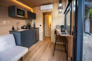 a kitchen with a sink and a table in a tiny house at Cabañas en Graus in Graus