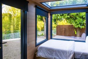 a room with a bed and a large window at Cabañas en Graus in Graus