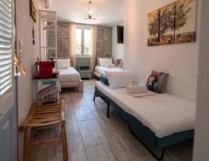 a room with three beds and a chair in it at Naiada Home with Sea View in Mykonos