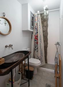 a bathroom with a toilet and a sink at Naiada Home with Sea View in Mykonos +21 photos