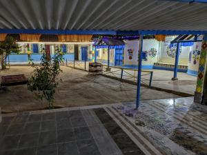 a large room with blue walls and a building at White Land Village Stay in Dhordo