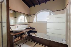 a bathroom with a sink and a tub at Orotava The Home - Vacational rental with the lifestyle of 1700 and the comfort of 2022 in La Orotava +26 photos