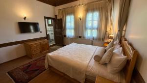 a bedroom with a large bed and a television at Rum Evi By Secret Sense Collection in Safranbolu