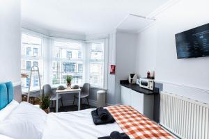 a bedroom with a bed and a table in a room at The Bay by Guestz in Morecambe