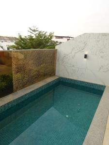 a swimming pool on the side of a building at Room View boutique in Luanda +4 photos