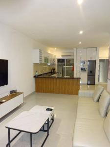 a large living room with a couch and a kitchen at Room View boutique in Luanda