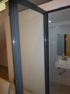 a sliding glass door with a sink in a bathroom at Room View boutique in Luanda