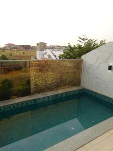 a swimming pool on the roof of a building at Room View boutique in Luanda