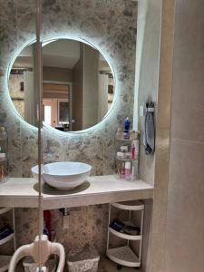 a bathroom with a sink and a mirror at Viola Studio Apartman in Bar