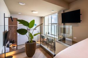 a room with a large vase with a plant in it at Hotel De Zeevaartschool in Vlissingen