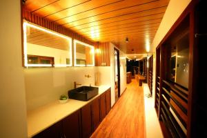 a bathroom with a sink and a counter top at Boats N Beds - Alleppey Houseboats - Alleppey Boat House - Luxury Premium Houseboats in Alleppey