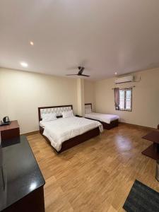 a large bedroom with a bed and a window at TSR Grand Hotel in Bhogāpuram