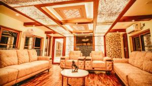 a living room with couches and chairs and a table at Boats N Beds - Alleppey Houseboats - Alleppey Boat House - Luxury Premium Houseboats in Alleppey
