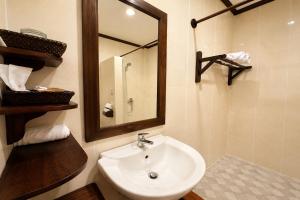 a bathroom with a sink and a mirror at Luang Prabang Legend Hotel in Luang Prabang +36 photos