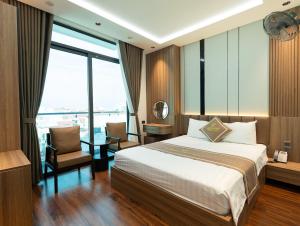 a hotel room with a bed and a large window at Viet Phuong Center Hotel in Ninh Binh