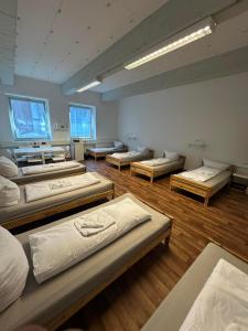 a large room with many beds in it at 2-Rent Group Hostel Rooms&Apartments GKP2 in Munich