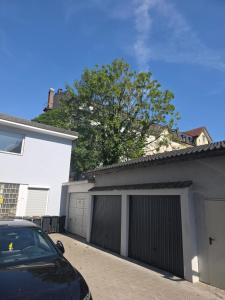 a black car parked in front of a garage at City Hotel in Rheinfelden