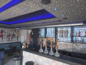 a bar with bottles of alcohol on a counter at City Hotel in Rheinfelden