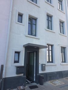 a white building with a door in front of it at City Hotel in Rheinfelden +1 photo