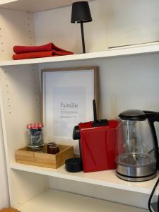 a shelf with a toaster and a blender on it at Lorenzo Apartments 05 in Burglengenfeld