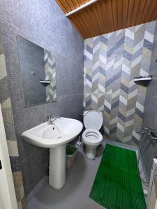 a bathroom with a sink and a toilet and a mirror at Хостел in Astana