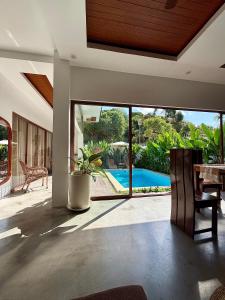 a living room with a view of a pool at The Hide El Nido Villas in El Nido
