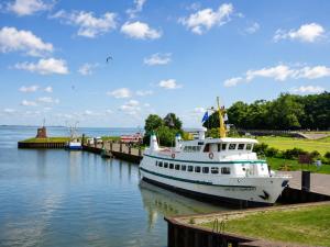 a boat docked at a dock on the water at Sand & Siel Dangast in Dangast