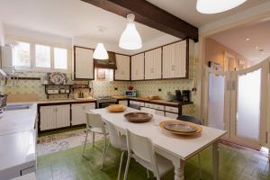 a kitchen with a table and chairs in it at Orotava The Home - Vacational rental with the lifestyle of 1700 and the comfort of 2022 in La Orotava