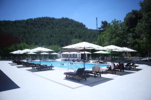 a swimming pool with lounge chairs and umbrellas at Rum Evi By Secret Sense Collection in Safranbolu