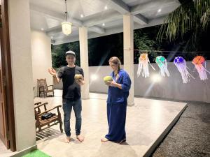 a man and a woman holding balls in a house at The Ceylon Slate in Tangalle