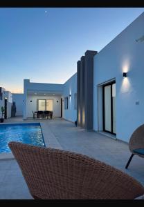 a villa with a swimming pool and a patio at Villa Tanit in Taguermess