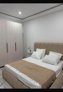 a bedroom with a large bed with two pillows at Villa Tanit in Taguermess +7 photos