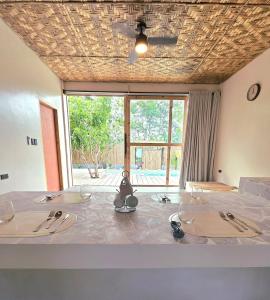 a room with a table with wine glasses on it at Wadi Residence in General Luna