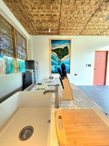 a kitchen with a sink and a counter top at Wadi Residence in General Luna +26 photos