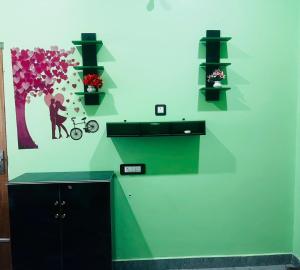 a green wall with a picture of a man and a bike at Aman Convention in Chāndbāli