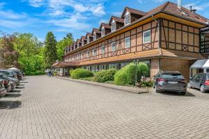a large building with cars parked in front of it at Haags Hotel Niedersachsenhof in Verden