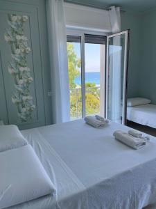 a bedroom with a bed with a view of the ocean at B&B Riviera Azzurra in Cirella